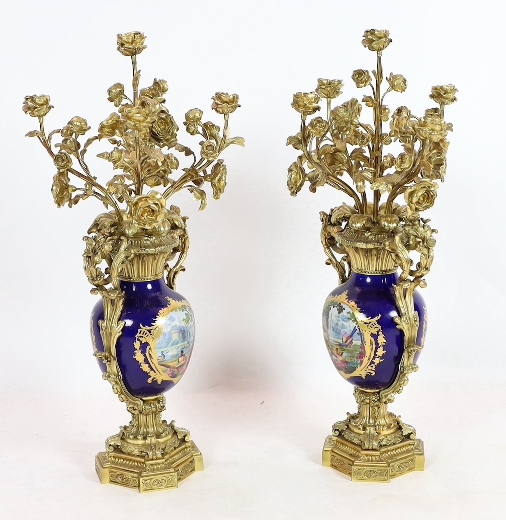 A pair of large French Sevres style ormolu mounted candelabra, in Louis XVI style, 19th century, 69cm high